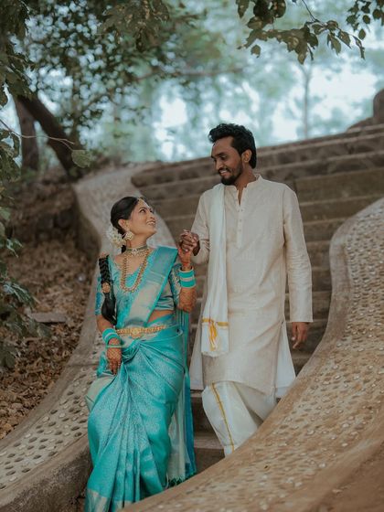 A candid moment of the couple walking down a flight of stairs, hand in hand. It's a beautiful, cinematic shot from their pre-wedding shoot.