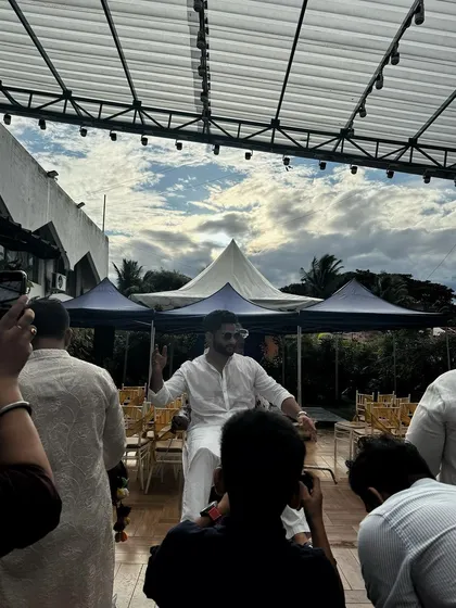 A guest enjoying the daytime festivities at our rooftop venue, with the open sky and canopies in the background.