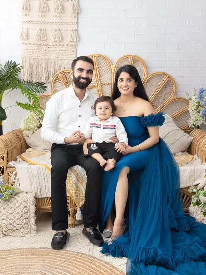 A beautiful family portrait in our boho-chic setup. The mother's elegant blue gown adds a touch of glamour to the relaxed, natural setting.