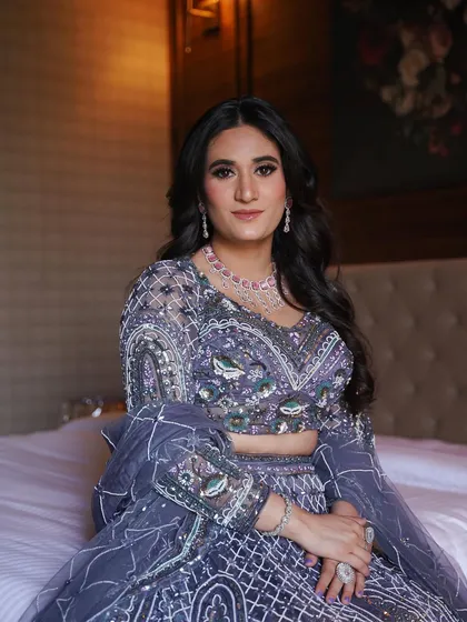 A relaxed portrait on the bed. The makeup is glamorous yet feels comfortable, perfect for a long night of festivities.