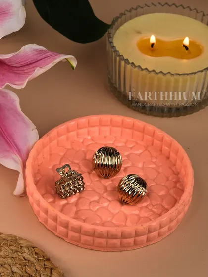 This round, peach-colored Jesmonite tray has a textured surface and is perfect for holding jewelry, keys, or other small treasures. It can also serve as a beautiful base for a candle.