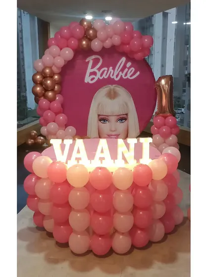 A straight-on shot of the Barbie party main table and backdrop.