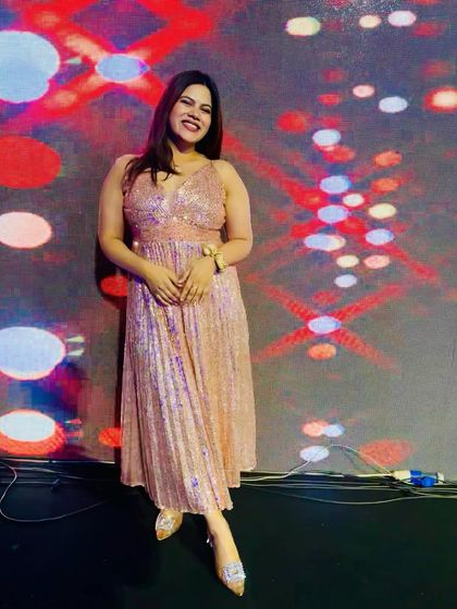 A moment of relaxation against the colourful stage backdrop before the Sangeet performances begin.