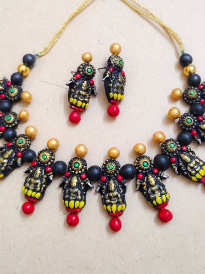 The same Mahalakshmi temple necklace design with red beads. Offering these color variations is key for festive sales.