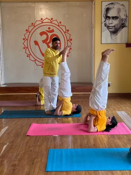 A view from our weekend advanced class, where students practice inversions with the careful supervision of an instructor.