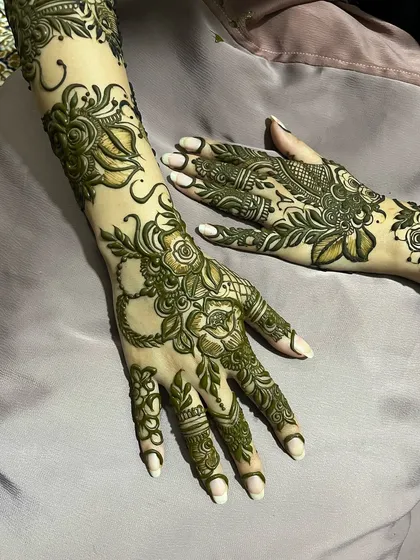 A fresh application of a floral bridal design, showing the rich green color of my organic henna paste before it dries and stains the skin.