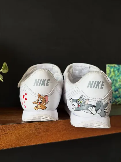 A close-up of the back of the kids' custom Nikes, featuring Tom and Jerry.
