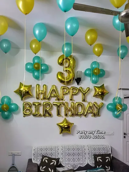 A simple home birthday decoration with helium balloons and foil letters.