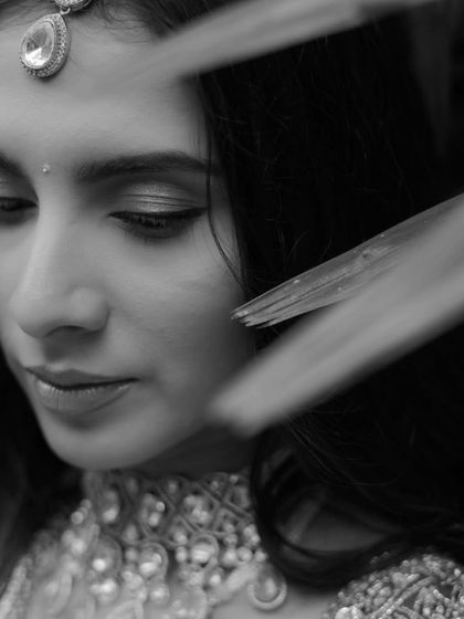 A delicate and beautiful close-up of the bride in black and white, her features softly illuminated.