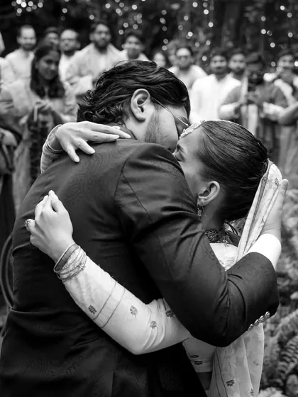 Ramisa and Omar share a tight hug after their nikaah ceremony. This black and white photo captures the raw emotion and relief of finally being united as husband and wife, with their loved ones looking on.