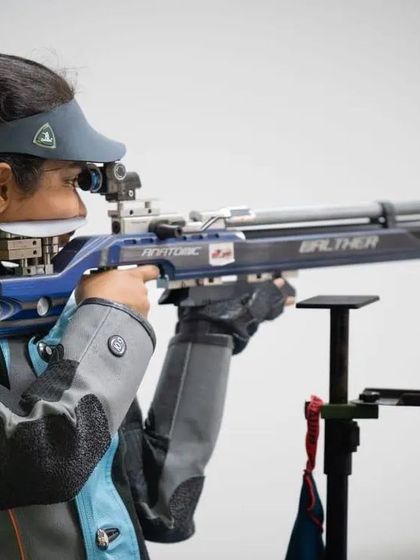 A shooter demonstrates the classic standing position for the 10m Air Rifle, a discipline that improves patience and hones skill.
