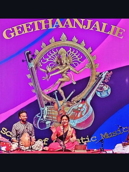 A beautiful stage setup for a concert by Geethaanjalie School of Carnatic Music in Melbourne, Australia. The vibrant backdrop added to the festive atmosphere of the performance.