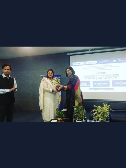 Being presented with a plant, a sustainable token of appreciation, at the cyber awareness event.