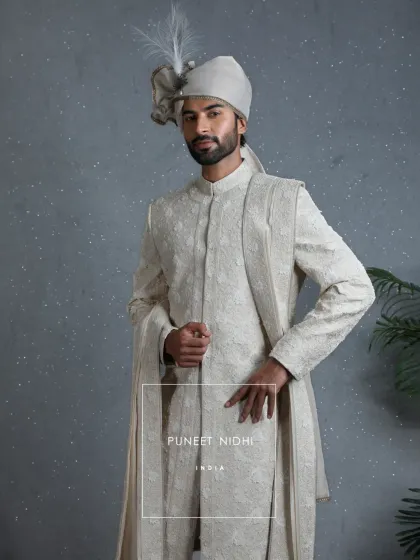 A closer look at the 3D floral embellished ivory sherwani with its matching stole. The design celebrates not just a ritual, but a journey of heritage and togetherness.