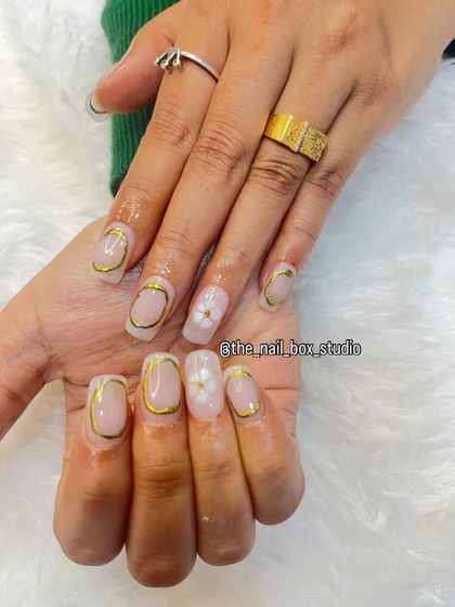 I love how the gold chrome outlines the nail shape, creating a very chic and artistic effect. The small flower adds a soft, feminine touch.