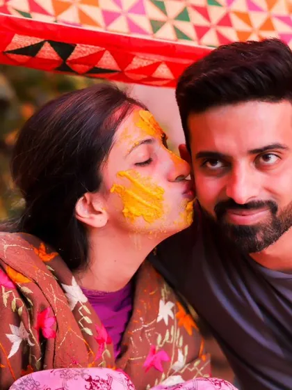 A playful and affectionate kiss during the Haldi ceremony. This colourful, candid shot is full of love and fun, perfectly capturing the spirit of the celebration.