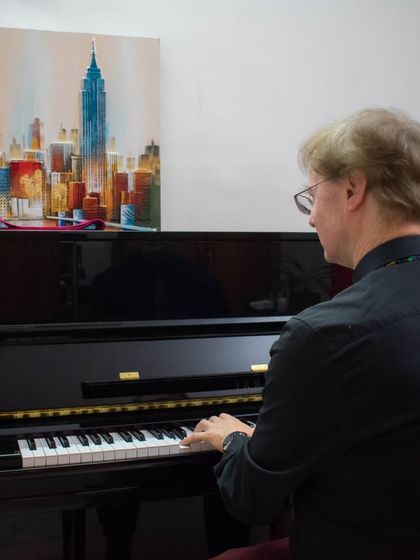 Mr. Richard Lewis, an esteemed examiner from ABRSM, playing the piano at our BEML branch during a recent examination session. We host official exams at our own centers.