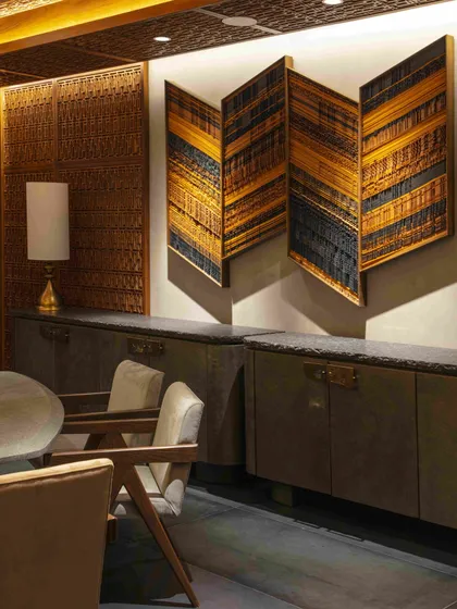 A custom-designed sideboard and a folded, layered art piece in the Bammi dining room. Every element is curated to contribute to the room's narrative of history and artistry.