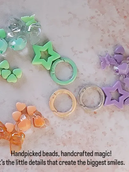 Handpicked beads and handcrafted magic. This image shows the raw materials for my pastel keychains, including star clasps and heart, star, and bow beads in green, orange, and purple.