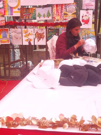 Here I am, adding the finishing touches to a sample cap before the carnival rush begins. I always prepare a few examples to spark the kids' imagination.