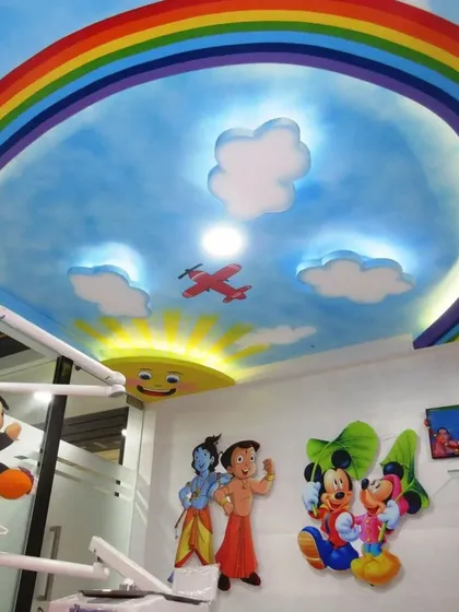 Ceilings are a great canvas. For this pediatric dentist's clinic, I painted a bright and cheerful sky with a rainbow, clouds, and an airplane to help make the space more welcoming and less intimidating for children.
