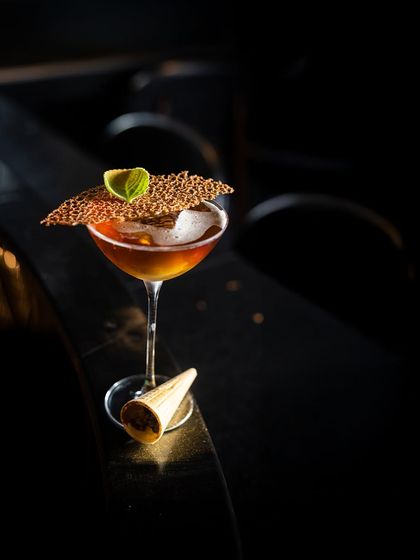 'The Wisdom' is a thoughtful blend of Whiskey, Pine Needle, Prekese Bark, and a Dry Aromatised Wine. It's a complex, spirit-forward drink for the discerning palate.