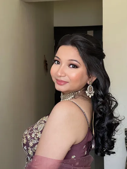 A side profile showing the beautiful hairstyle and makeup.