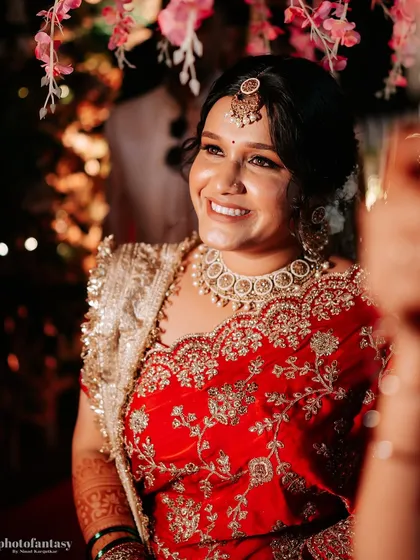 A happy, candid shot of the bride during her wedding celebrations.