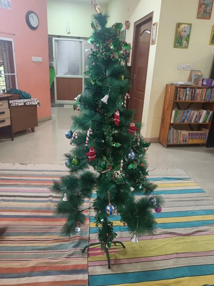 A photo of our fully decorated Christmas tree, the result of the children's wonderful collaborative effort.