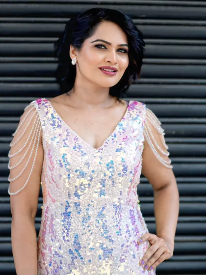 This iridescent sequin gown shimmers with every movement, reflecting a beautiful spectrum of pastel colors. It's a modern and glamorous choice for any special occasion.