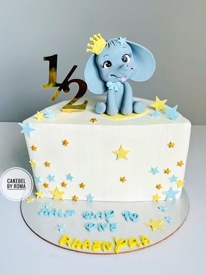 "Half way to one." An adorable half birthday cake with a cute elephant topper, celebrating six months of joy.