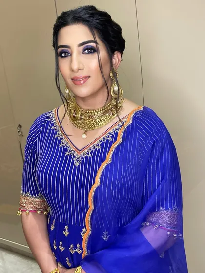 Acing this look for a family function. I gave her a bold blue smokey eye to match her royal blue suit, creating a striking and confident look.