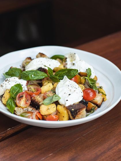 Our seasonal Mango Tuscan Salad is back. It's a refreshing mix of fresh mangoes, sourdough croutons, cherry tomatoes, and creamy burrata.