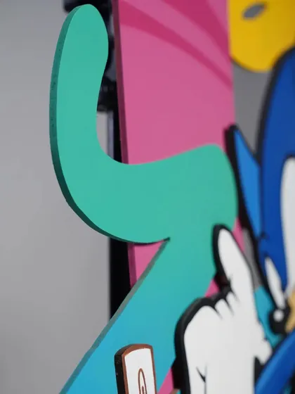 A detail shot showing the edge of a wood cutout on the Sonic piece. The precision of the cut allows for really clean and sharp color transitions.