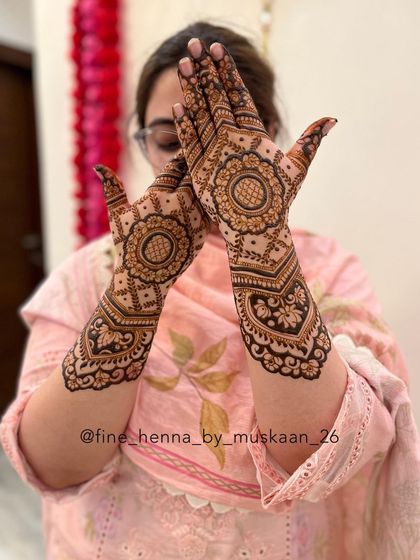 A full-arm design with a central mandala and intricate floral and paisley fillers.