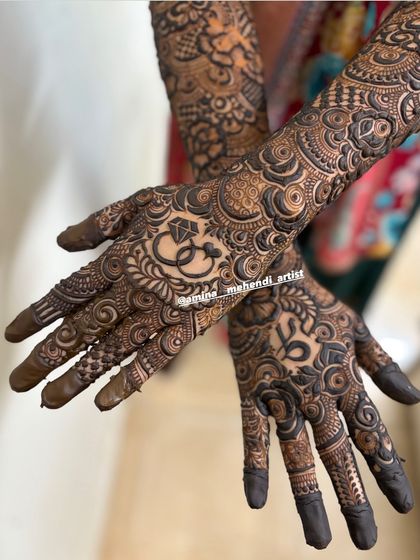 A close-up of the palms, showing the ring motif and the initials 'R' and 'S'.