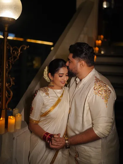 It was a joy to design this coordinated Deepavali outfit for the wonderful couple, Tharun and Sonal. For his off-white silk kurta, I added delicate, asymmetrical gold embroidery on the shoulder. This created a beautiful harmony with her matching saree, telling a cohesive story for their first festival together as a married couple.