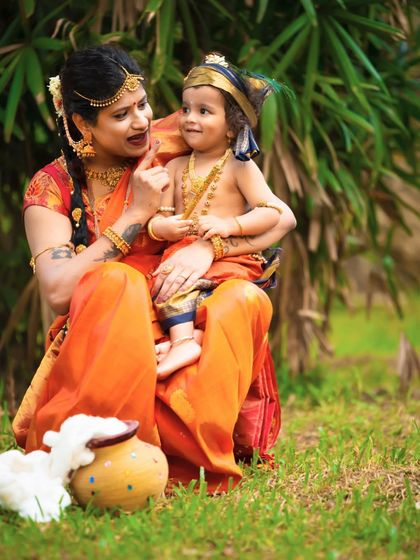 A sweet, interactive moment between mother and son during their Krishna-themed photoshoot. I love capturing these genuine connections.