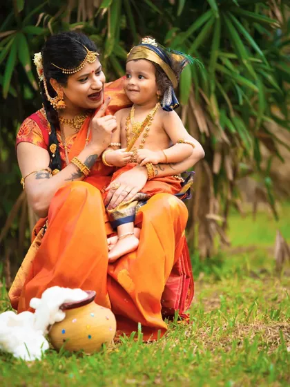 A sweet, interactive moment between mother and son during their Krishna-themed photoshoot. I love capturing these genuine connections.