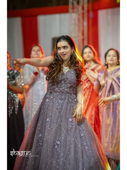A guest leads the way on the dance floor, her expression full of fun and energy. These are the moments that bring a wedding party to life.