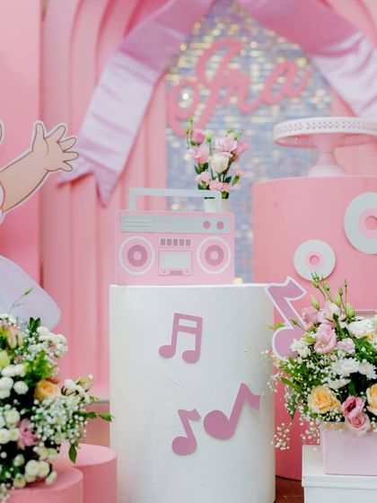 A close-up of a retro boombox prop and music note cutouts, key elements of our 'Dancing to One' theme.