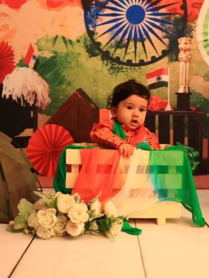 A thoughtful moment during the Independence Day shoot. The setup includes various patriotic symbols like the flag and the Ashoka Chakra.
