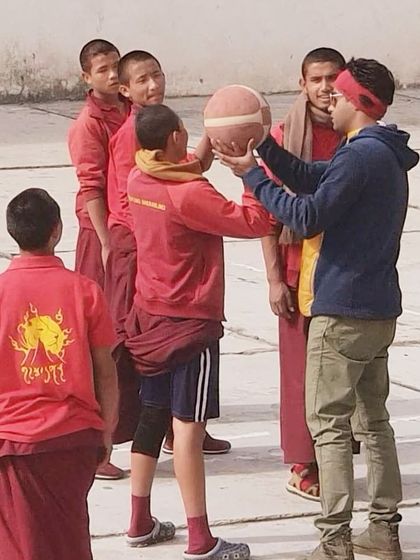 Correcting the grip and form for a shot. These interactions remind us that coaching is about connecting with people and sharing a passion, no matter where you are.