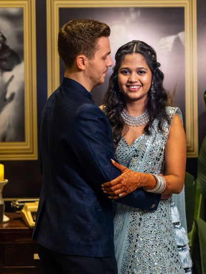An intimate moment between the bride and groom. Her reception look features a sparkling lehenga with soft, open hair and a diamond necklace, a modern and elegant choice for the evening's festivities.