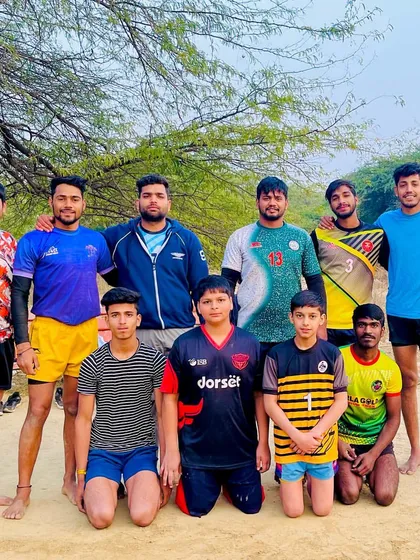 A group of our junior and senior players posing for a photo with me after a practice session on our home ground.