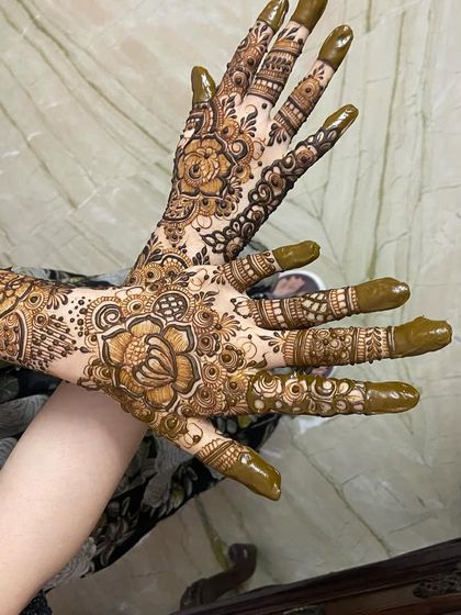 Both hands, showing the back and front of this floral design.