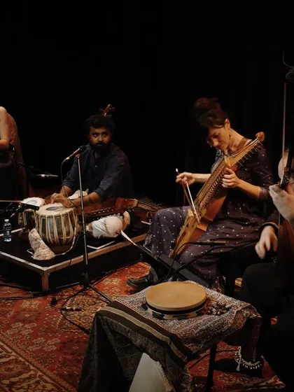 A moment from our 'Sangam, Confluences' performance. This image showcases the heart of our musical fusion, with artists playing the Indian Tabla and the Swedish Nyckelharpa side-by-side in an intimate, dramatic setting.