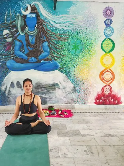 Finding my center in Rishikesh. Here I am in Padmasana (lotus pose) in front of a beautiful mural of Lord Shiva and the seven chakras, connecting to the spiritual energy of this sacred place.