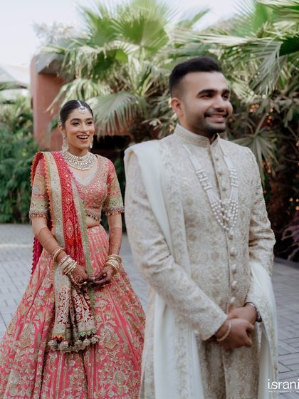 The bride's joyful expression as she sees her groom. This 'first look' photo is full of anticipation and love.