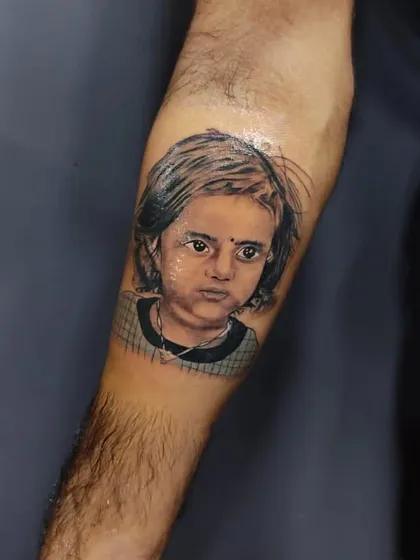 Creating a realistic portrait of a loved one is a responsibility I take very seriously. This tattoo of a client's child was done with great attention to detail to capture her likeness and create a lasting tribute.